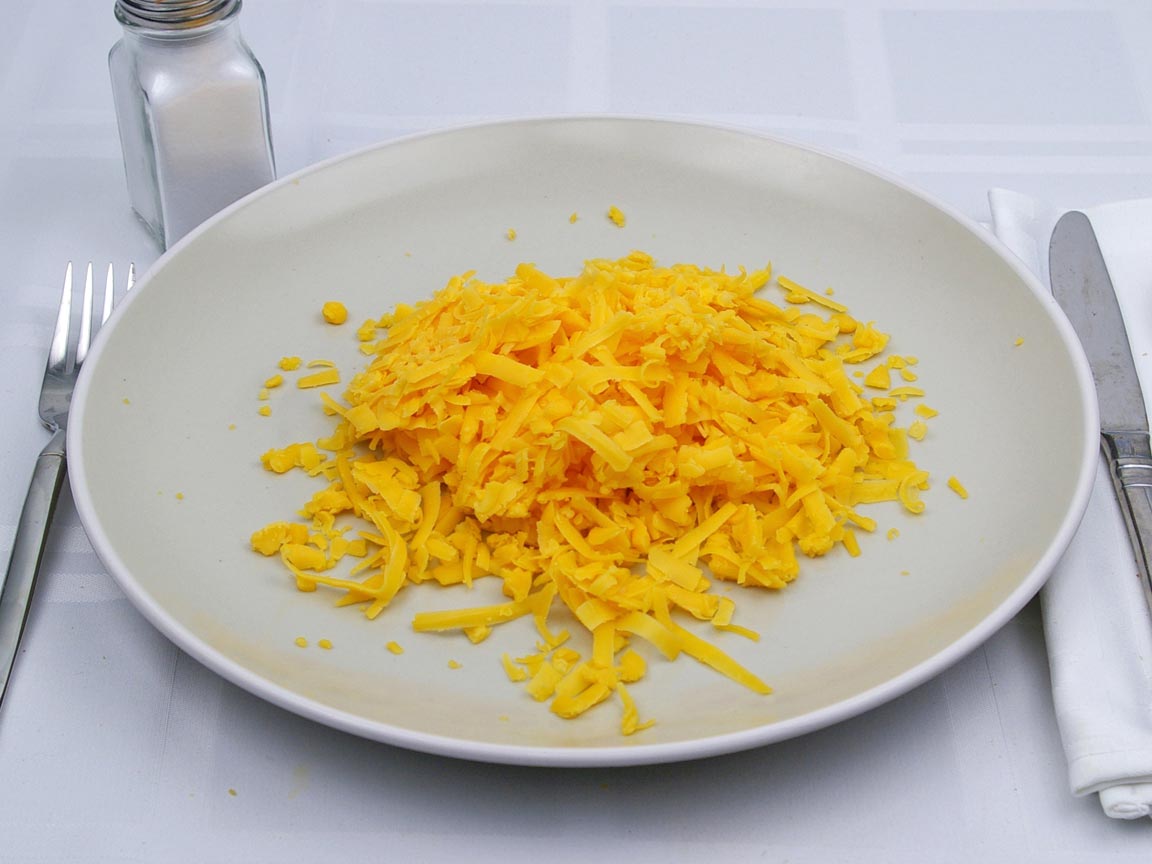 Calories in 1.5 cup(s) of Cheddar Cheese - Shredded