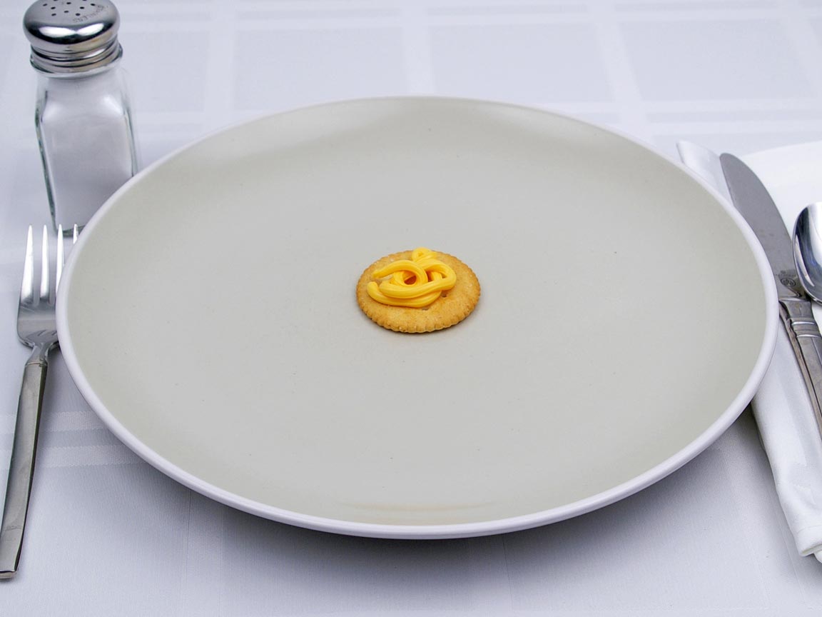 Calories in 1 tsp(s) of Easy Cheese - Shown on Cracker