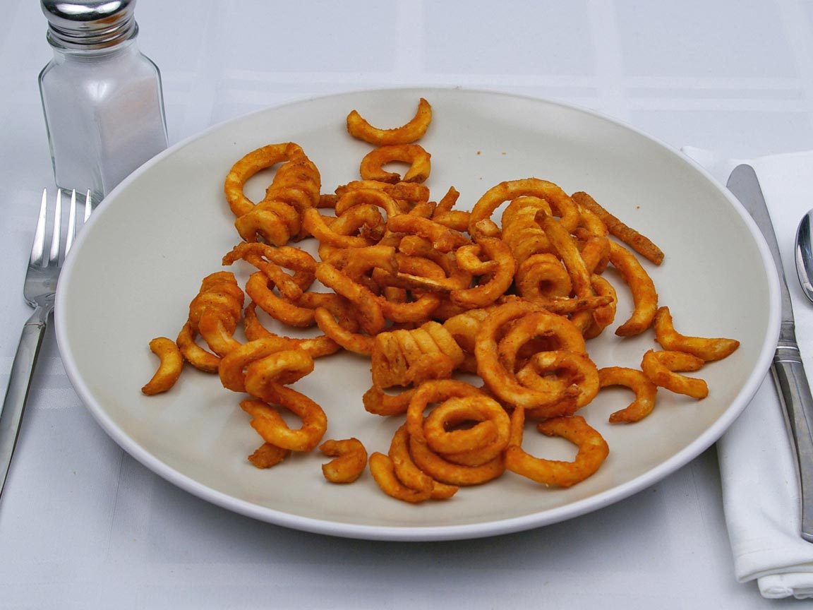 Calories in 0.75 large of Jack in the Box - Seasoned Curly Fries