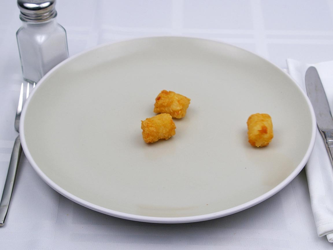 Calories in 25 grams of Tater Tots -Frozen Oven Heated