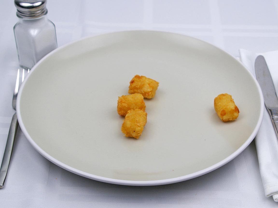 Calories in 34 grams of Tater Tots -Frozen Oven Heated